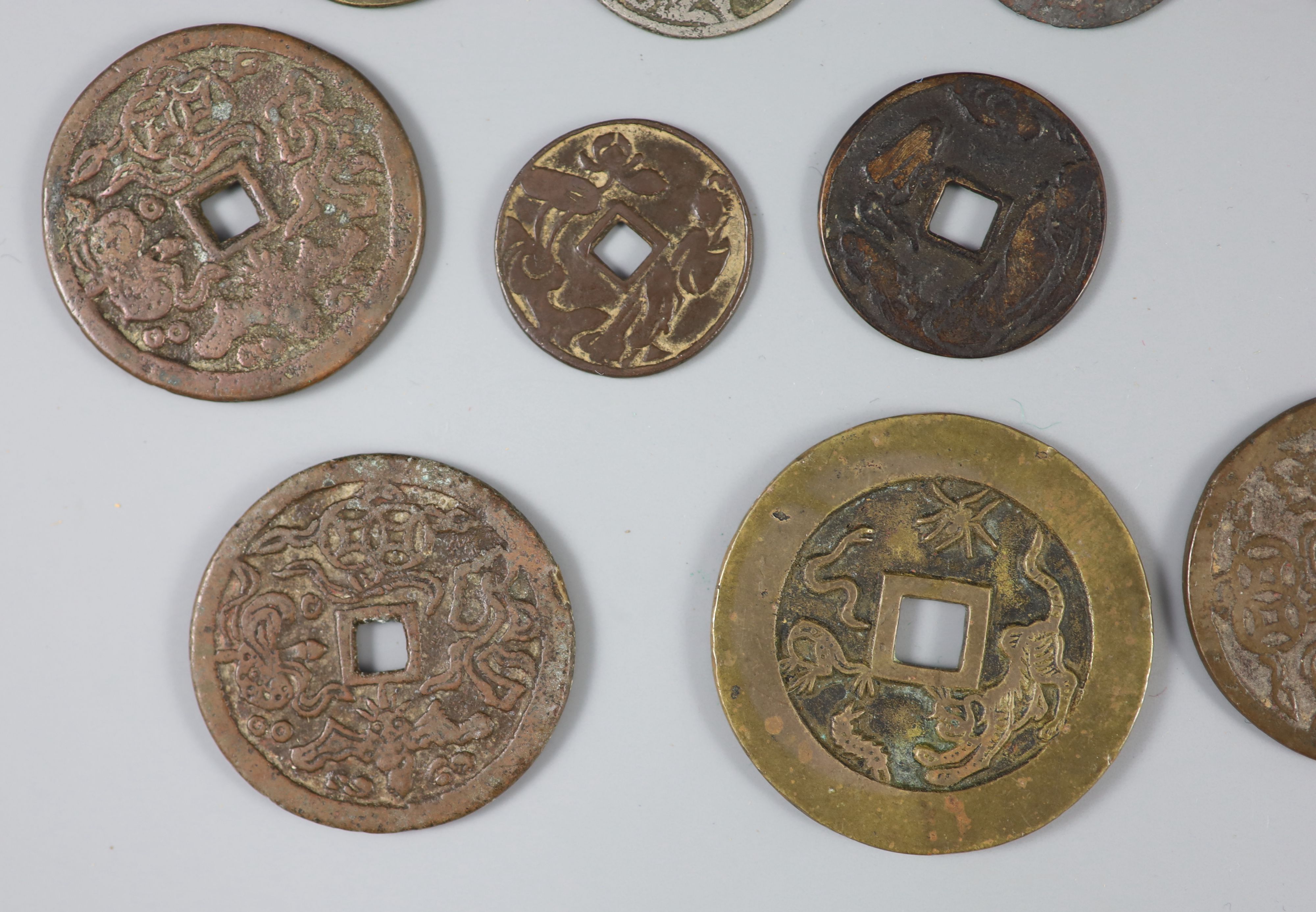 China, a group of 26 bronze or brass charms or amulets, Qing dynasty,